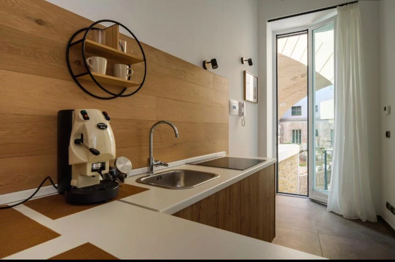 Camera Tripla — cucina con balcone aperto